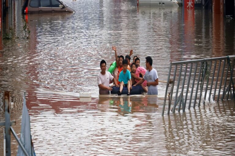 China Moves Residents Out of Flooded Areas, Drains Tunnels