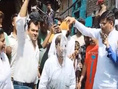 Delhi: AAP councillor jumps into sewage to clean it, gets milk bath later