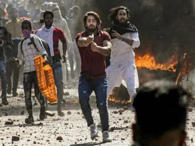 Watch: Man who pointed pistol at cop during Delhi riots receives hero’s welcome home